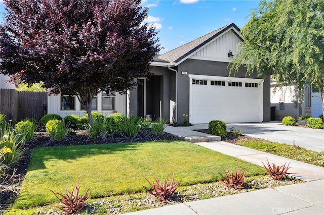 748 Expedition Way W, Madera, CA 93636 - view of front of house featuring a garage, concrete driveway, and stucco siding