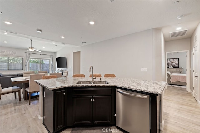 748 Expedition Way W, Madera, CA 93636 - kitchen featuring dishwasher, a sink, open floor plan, light wood finished floors, and a center island with sink