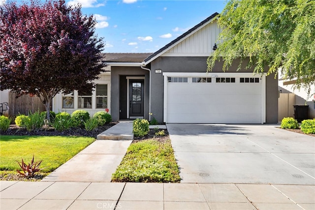 748 Expedition Way W, Madera, CA 93636 - view of front of house with stucco siding, a garage, concrete driveway, and a front yard