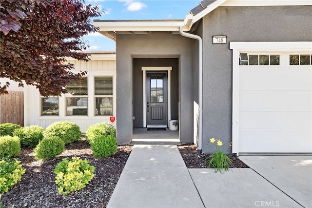 748 Expedition Way W, Madera, CA 93636 - entrance to property with a garage and stucco siding