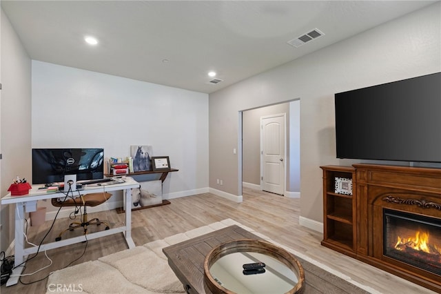 748 Expedition Way W, Madera, CA 93636 - office area featuring light wood finished floors, baseboards, a glass covered fireplace, and recessed lighting