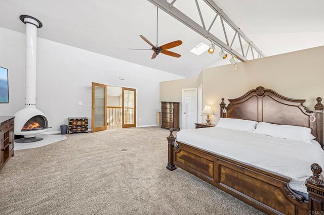 3016 Alta Vista Dr, Fallbrook, CA 92028 - carpeted bedroom with high vaulted ceiling, a wood stove, a ceiling fan, and baseboards