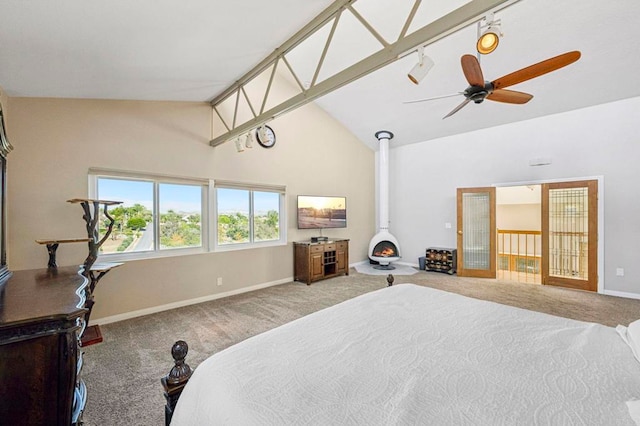 3016 Alta Vista Dr, Fallbrook, CA 92028 - bedroom featuring carpet floors, baseboards, high vaulted ceiling, and a wood stove