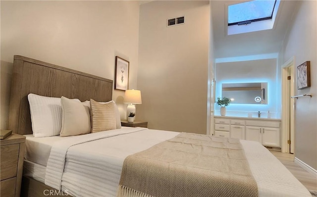 77 Lakepines, Irvine, CA 92620 - bedroom with a skylight, light wood finished floors, and a towering ceiling