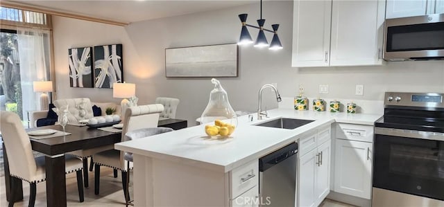 77 Lakepines, Irvine, CA 92620 - kitchen with stainless steel appliances, a sink, a peninsula, open floor plan, and light countertops