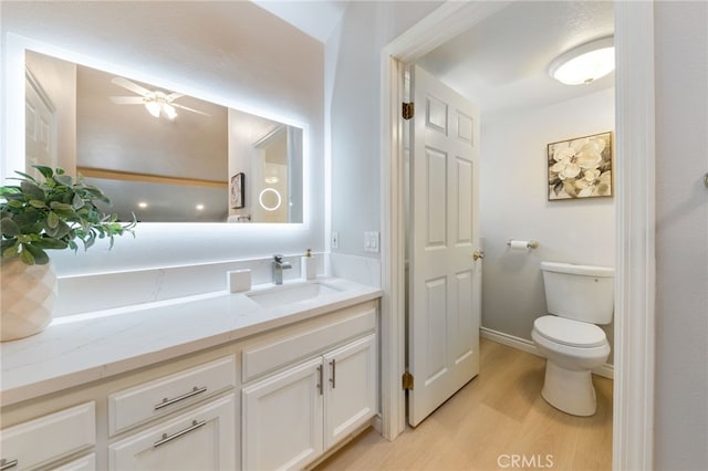 77 Lakepines, Irvine, CA 92620 - bathroom featuring wood finished floors, toilet, vanity, ceiling fan, and baseboards