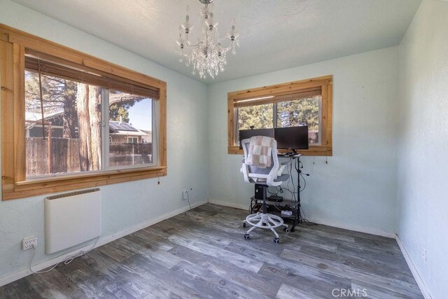 817 E Mountain View Blvd, Big Bear City, CA 92314 - home office with radiator heating unit, healthy amount of natural light, a chandelier, and wood finished floors