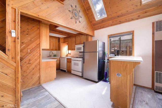 817 E Mountain View Blvd, Big Bear City, CA 92314 - kitchen featuring white appliances, a heating unit, a skylight, light countertops, and a peninsula