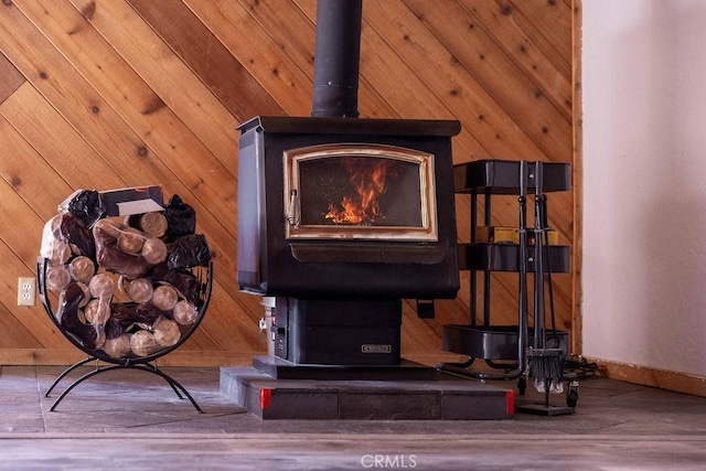 817 E Mountain View Blvd, Big Bear City, CA 92314 - detailed view of a wood stove, baseboards, and wood walls