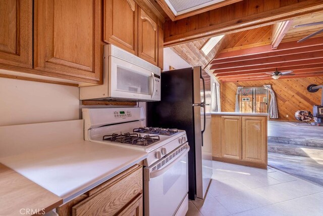 817 E Mountain View Blvd, Big Bear City, CA 92314 - kitchen with white appliances, wooden walls, light countertops, light tile patterned floors, and a ceiling fan