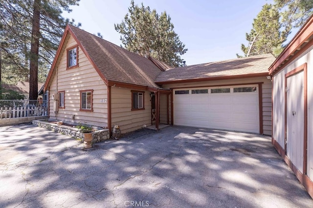 817 E Mountain View Blvd, Big Bear City, CA 92314 - view of property exterior featuring roof with shingles, a garage, and driveway
