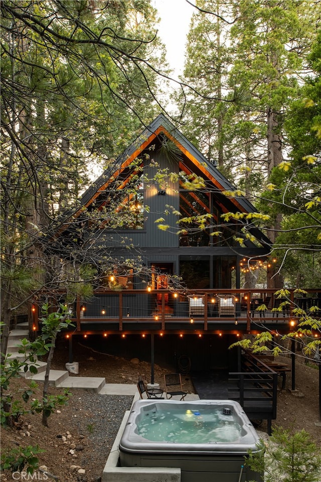 607 Old Toll Rd, Lake Arrowhead, CA 92352 - back of house featuring a hot tub and a deck