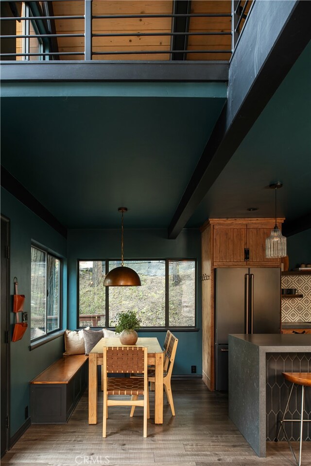 607 Old Toll Rd, Lake Arrowhead, CA 92352 - dining space with wood finished floors, baseboards, and beamed ceiling
