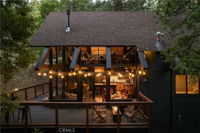 607 Old Toll Rd, Lake Arrowhead, CA 92352 - rear view of house with a wooden deck and roof with shingles