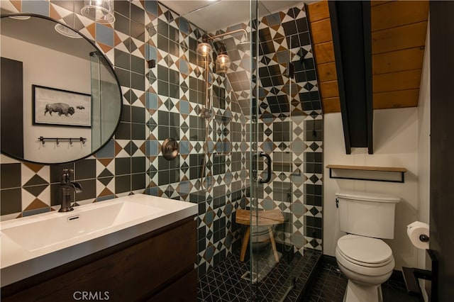 607 Old Toll Rd, Lake Arrowhead, CA 92352 - full bath featuring a tile shower, toilet, tile walls, vanity, and decorative backsplash