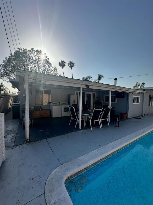 5914 N Rockvale Ave, Azusa, CA 91702 - rear view of house with a patio area, an outdoor pool, washing machine and dryer, and a hot tub
