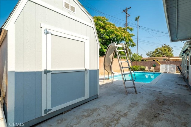 5914 N Rockvale Ave, Azusa, CA 91702 - view of pool with a water slide, a storage shed, a fenced backyard, and a patio area