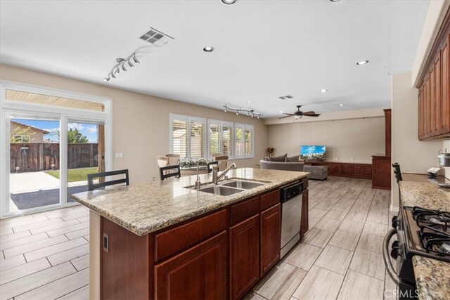 27109 Woodglen Ln, Moreno Valley, CA 92555 - kitchen with a sink, dishwasher, gas range, a kitchen island with sink, and ceiling fan