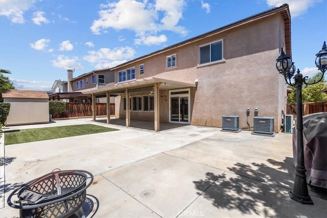 27109 Woodglen Ln, Moreno Valley, CA 92555 - rear view of property with stucco siding, a fenced backyard, central air condition unit, and a patio