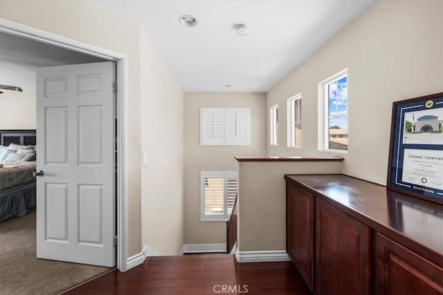 27109 Woodglen Ln, Moreno Valley, CA 92555 - hallway with an upstairs landing, baseboards, and dark wood-type flooring