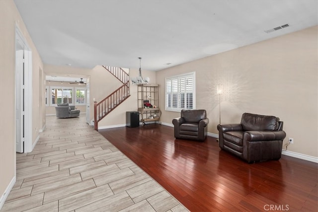 27109 Woodglen Ln, Moreno Valley, CA 92555 - living area with wood finished floors, baseboards, a chandelier, and ceiling fan