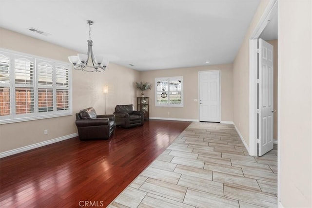 27109 Woodglen Ln, Moreno Valley, CA 92555 - entrance foyer featuring a chandelier, light wood finished floors, and baseboards