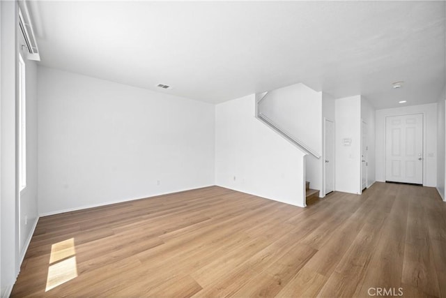 1349 Gordon Ct, Beaumont, CA 92223 - unfurnished living room with light wood-style floors and stairway