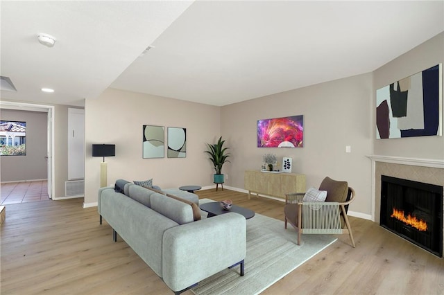 43334 32nd St W Unit 12, Lancaster, CA 93536 - living room featuring a fireplace, light wood finished floors, and baseboards