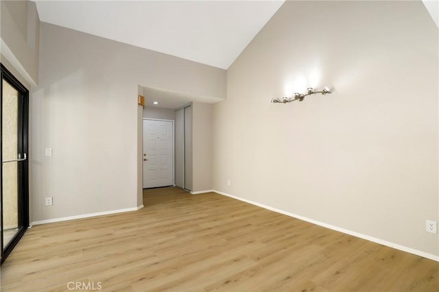 43334 32nd St W Unit 12, Lancaster, CA 93536 - unfurnished room featuring vaulted ceiling, light wood-type flooring, and baseboards