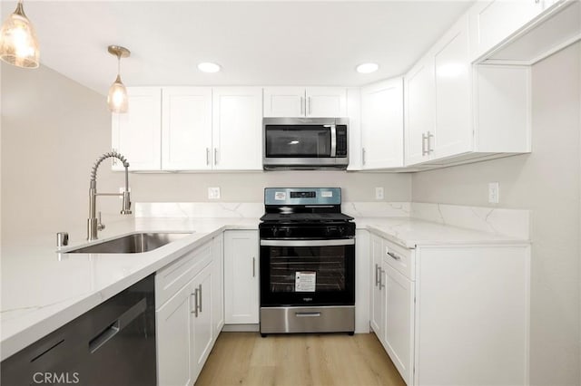 43334 32nd St W Unit 12, Lancaster, CA 93536 - kitchen featuring stainless steel appliances, a sink, white cabinets, and recessed lighting
