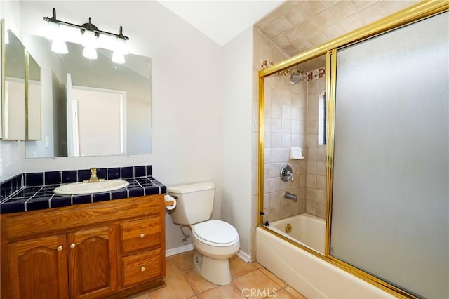 43334 32nd St W Unit 12, Lancaster, CA 93536 - full bathroom with tile patterned floors, toilet, vanity, enclosed tub / shower combo, and baseboards