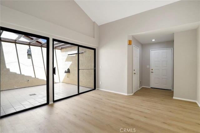 43334 32nd St W Unit 12, Lancaster, CA 93536 - unfurnished room with wood finished floors, vaulted ceiling, and baseboards
