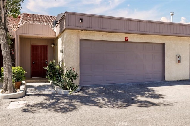 43334 32nd St W Unit 12, Lancaster, CA 93536 - townhome / multi-family property with stucco siding, driveway, and a garage