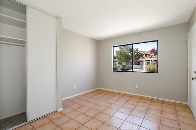 43334 32nd St W Unit 12, Lancaster, CA 93536 - unfurnished bedroom featuring a closet and light tile patterned floors