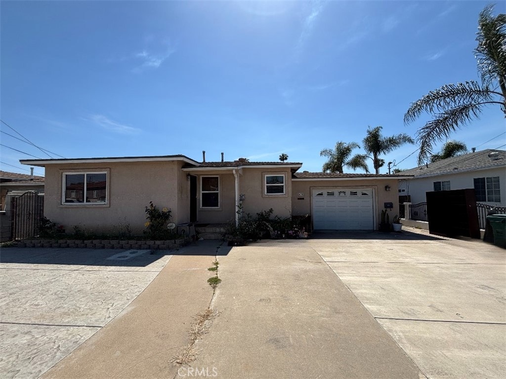 678 Ash Ave, Chula Vista, CA 91910 - single story home with stucco siding, an attached garage, and driveway