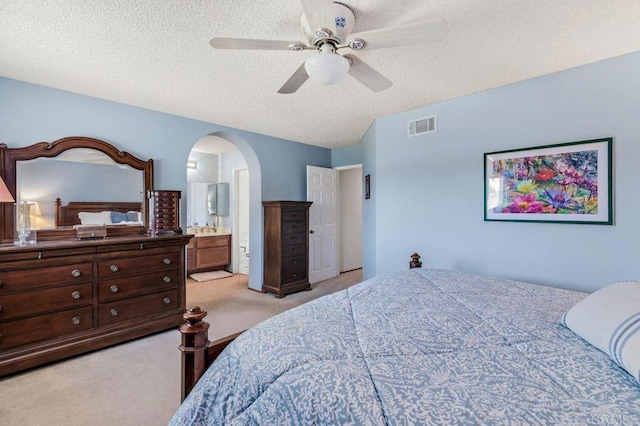 1064 Glen Arbor Dr, Encinitas, CA 92024 - bedroom featuring light carpet, arched walkways, a textured ceiling, a ceiling fan, and connected bathroom