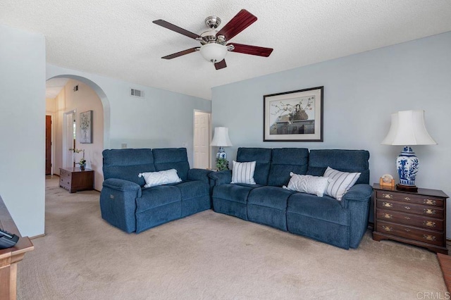 1064 Glen Arbor Dr, Encinitas, CA 92024 - living room with ceiling fan, carpet flooring, arched walkways, and a textured ceiling