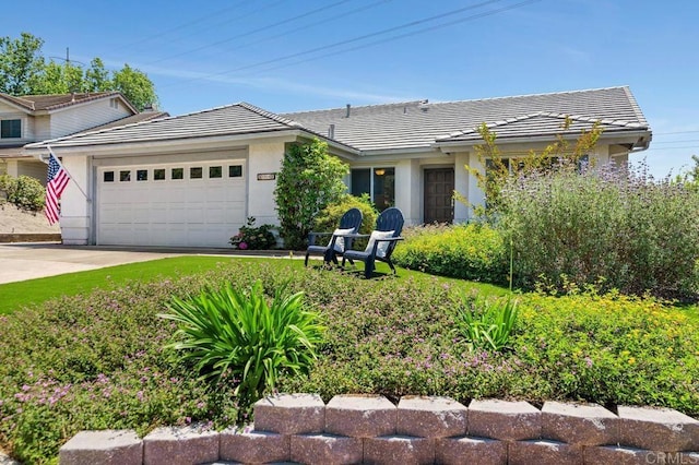 1064 Glen Arbor Dr, Encinitas, CA 92024 - view of front of house with an attached garage, a tiled roof, stucco siding, and concrete driveway