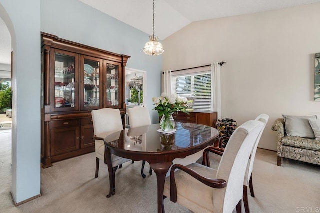 1064 Glen Arbor Dr, Encinitas, CA 92024 - dining room with light colored carpet, arched walkways, plenty of natural light, lofted ceiling, and a chandelier