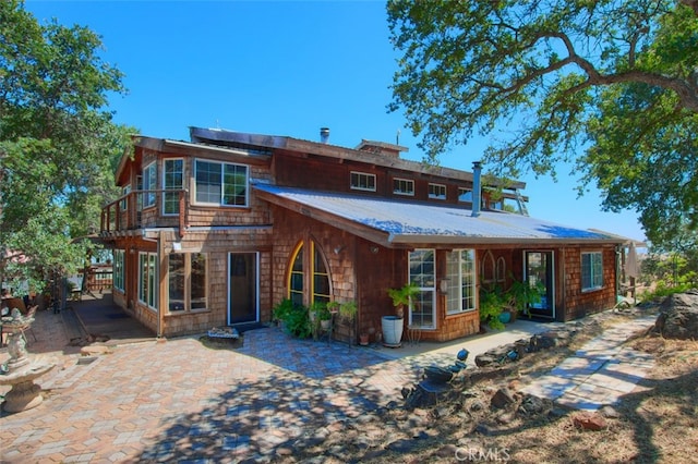 2380 Old Hwy, Catheys Valley, CA 95306 - view of front facade with roof mounted solar panels, a patio area, and metal roof