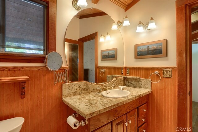 2380 Old Hwy, Catheys Valley, CA 95306 - bathroom with a wainscoted wall, vanity, toilet, and wooden walls