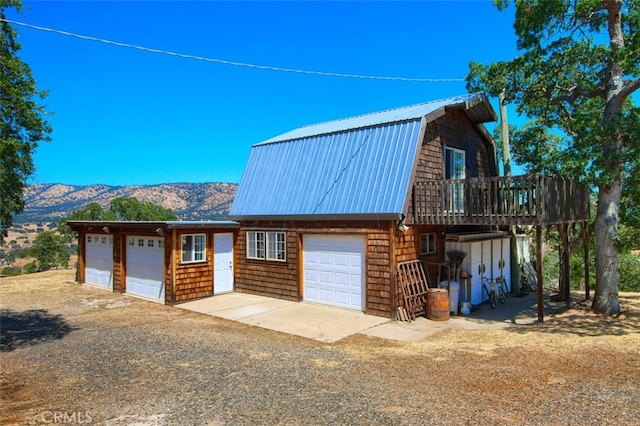 2380 Old Hwy, Catheys Valley, CA 95306 - view of front of property with a gambrel roof, a detached garage, metal roof, and a deck with mountain view
