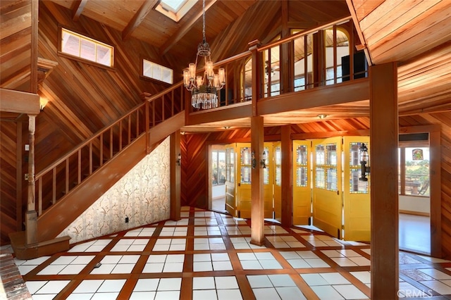 2380 Old Hwy, Catheys Valley, CA 95306 - unfurnished living room with a skylight, inlaid floor details, a chandelier, healthy amount of natural light, and wood walls