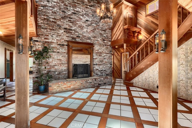 2380 Old Hwy, Catheys Valley, CA 95306 - unfurnished living room with inlaid floor details, wooden ceiling, a brick fireplace, tile patterned floors, and a towering ceiling