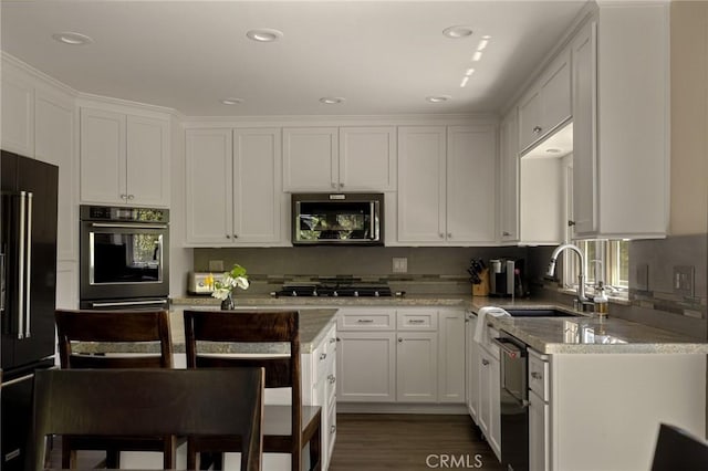 28960 Palisades Dr, Lake Arrowhead, CA 92352 - kitchen featuring appliances with stainless steel finishes, a sink, white cabinetry, dark wood-style flooring, and recessed lighting