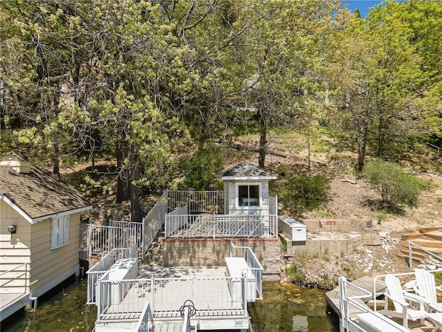 28960 Palisades Dr, Lake Arrowhead, CA 92352 - view of front facade with a dock, a water view, and an outdoor structure