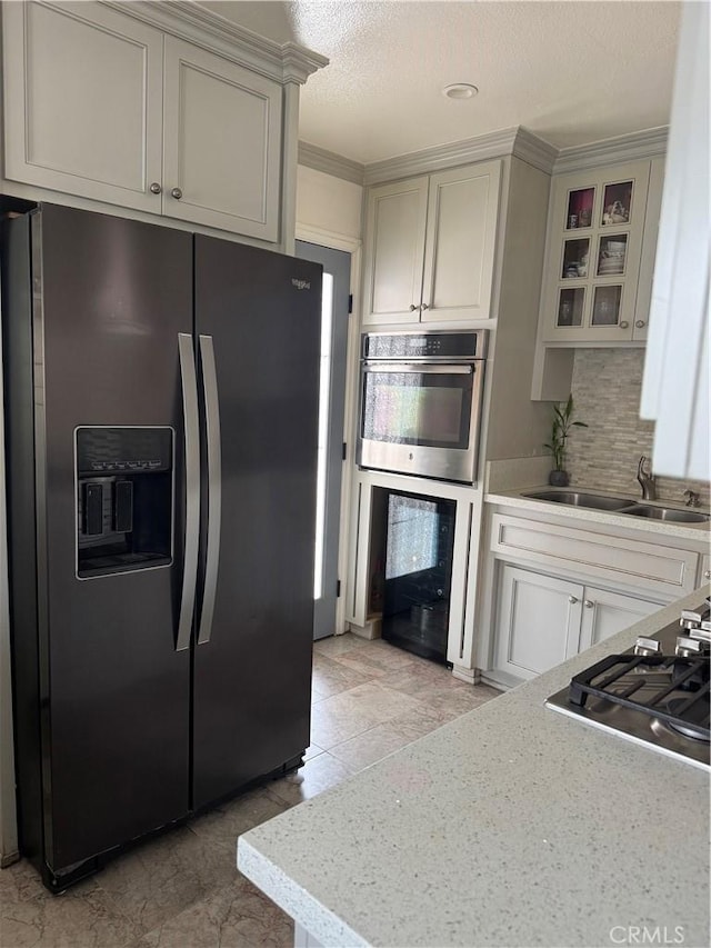 4552 Los Toros Ave, Pico Rivera, CA 90660 - kitchen featuring fridge with ice dispenser, decorative backsplash, light countertops, a sink, and glass insert cabinets