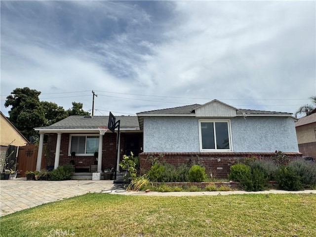 4552 Los Toros Ave, Pico Rivera, CA 90660 - view of front of property featuring brick siding and a front yard