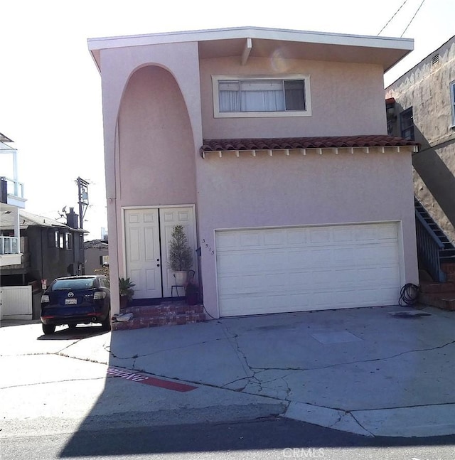 3513 Alma Ave, Manhattan Beach, CA 90266 - view of front of house with concrete driveway, stucco siding, and a garage