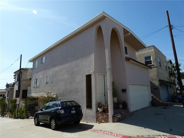 3513 Alma Ave, Manhattan Beach, CA 90266 - view of side of property featuring stucco siding, an attached garage, and driveway